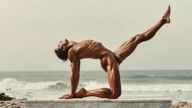 Sarvangasana. Shoulder-Stand. Yogi. Greek athlete, sweaty muscle yoga on wet marble 1m0s